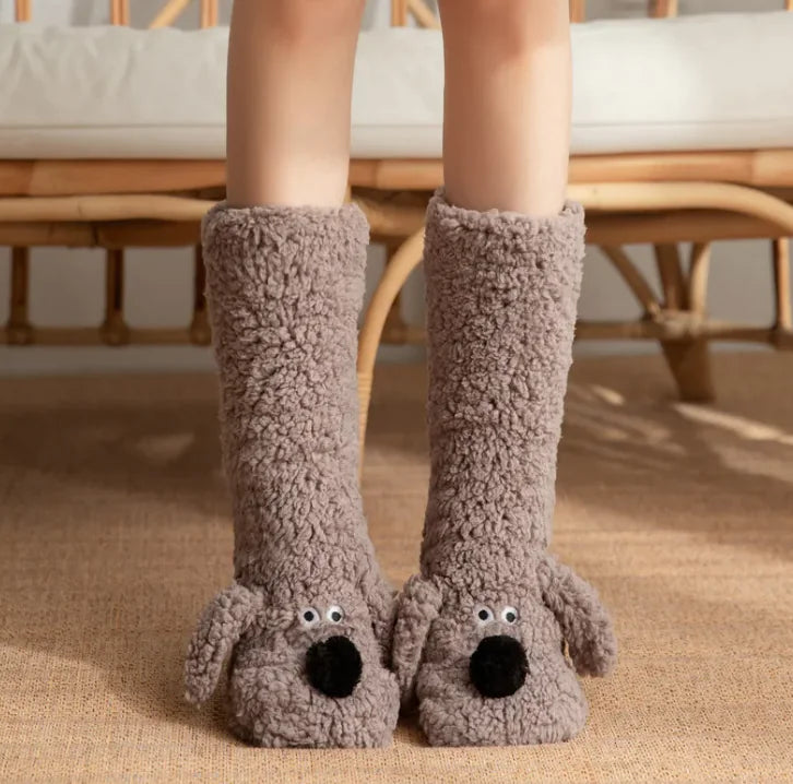 Brown fuzzy dog-shaped slippers worn by a person indoors.