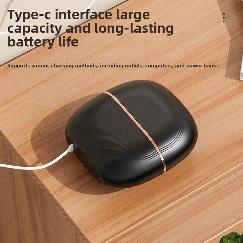 Black curl iron with Type-C interface on a wooden surface